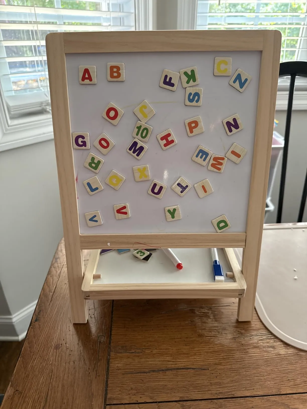 Magnetic letters scattered on whiteboard
